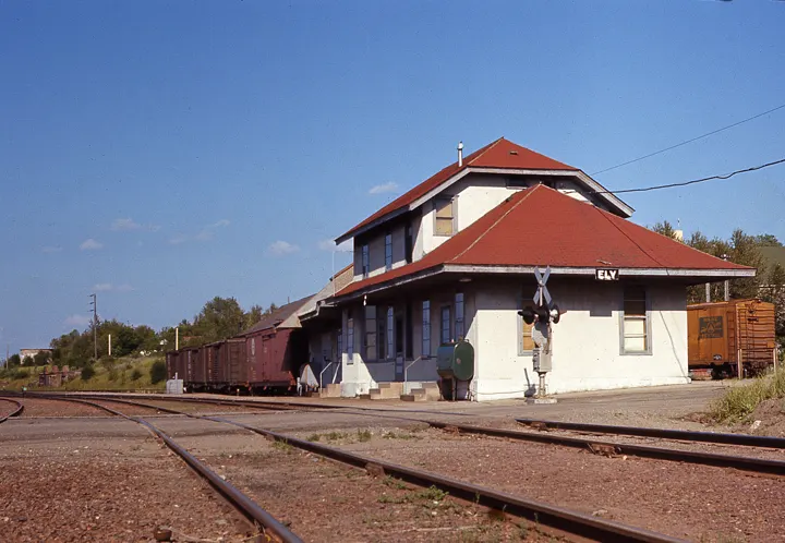 The red-roofed depot from across the tracks
