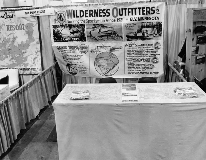 Wilderness Outfitters sport show booth with a banner reading Serving the Sportsman Since 1921