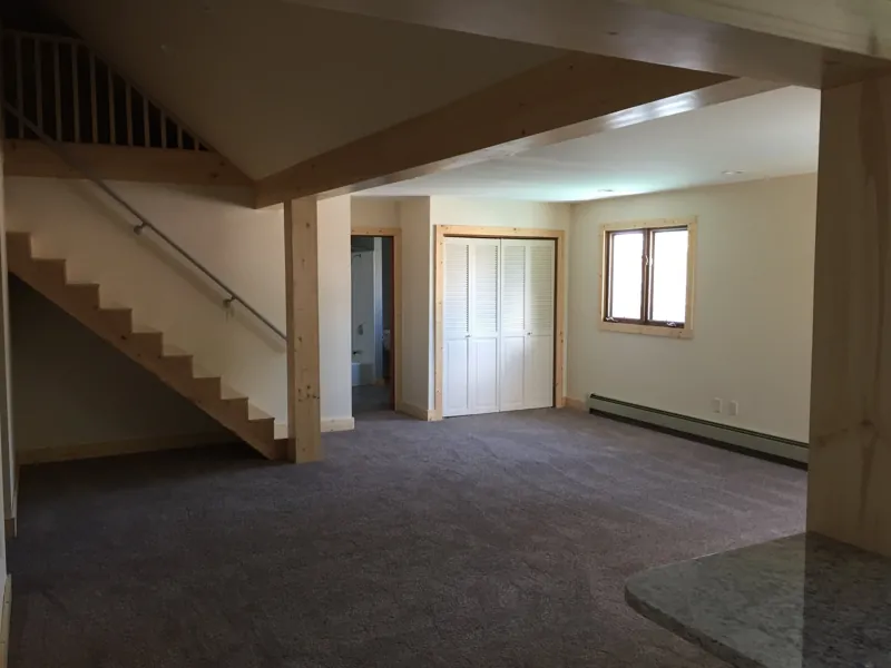 An open living area with stairs up to the loft