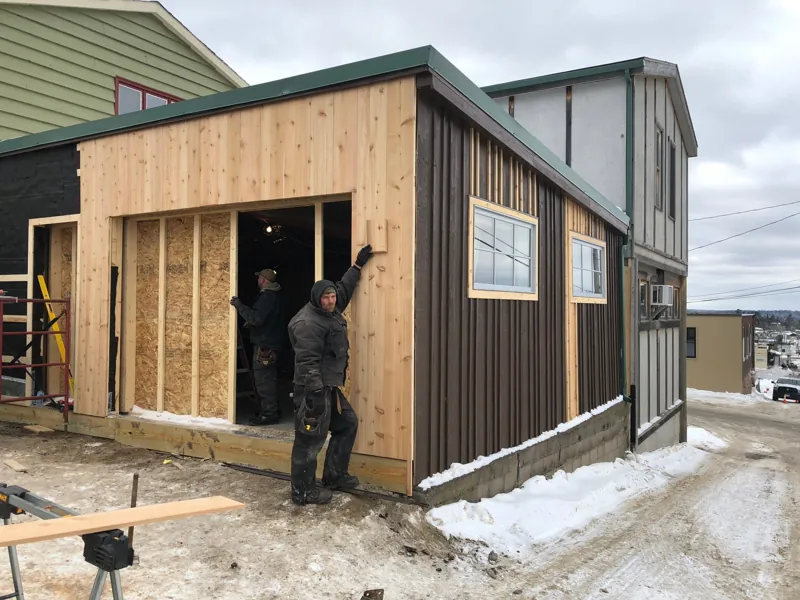 A builder standing in the doorway of the studio addition before the glass went in