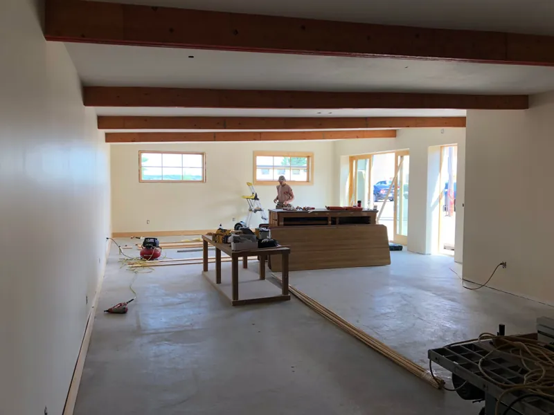 The open studio interior with exposed beams and a concrete floor