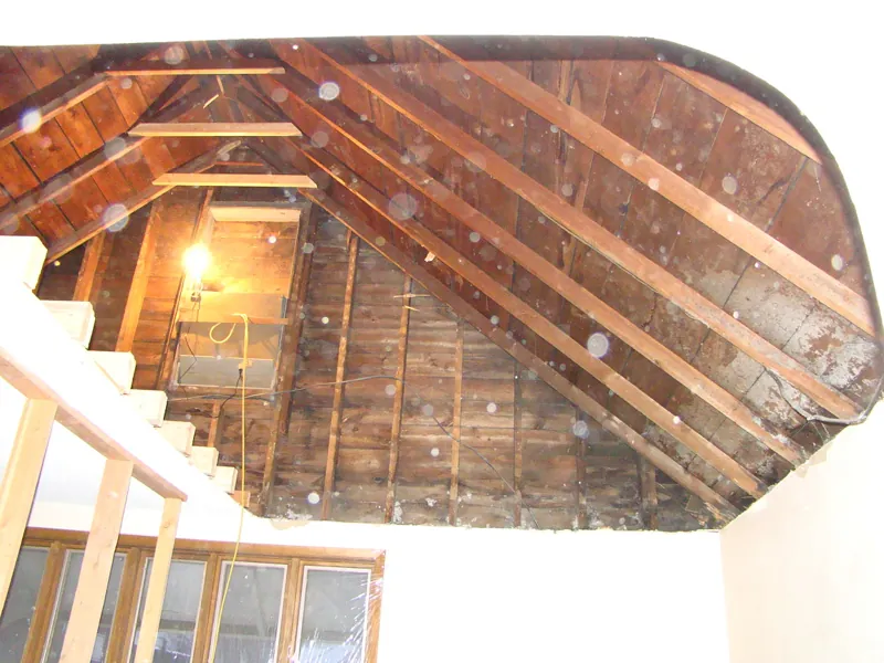 Looking up through an opening in the ceiling to the rafters