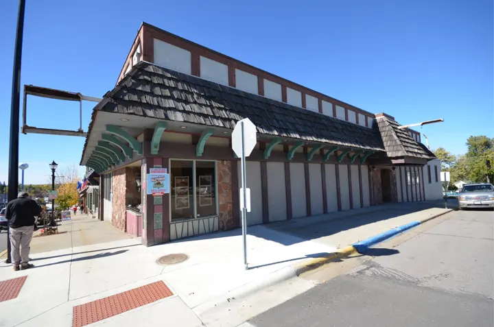 The corner with fieldstone, green brackets and a Sale Pending sign