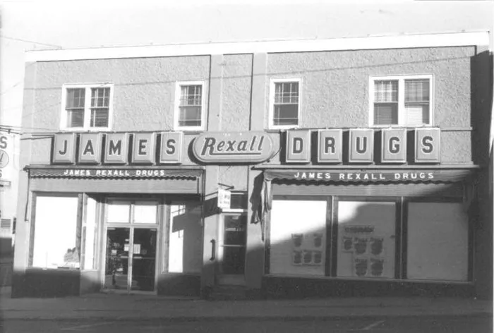 The stucco building with James Rexall Drugs letters across both storefronts