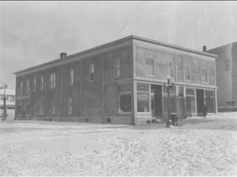 The two-story stucco building on a snowy day