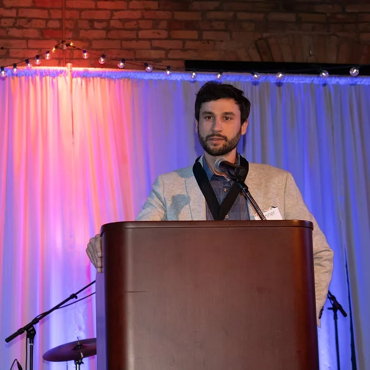 Tanner Ott speaking at a podium at the 2019 Rethos Icon Awards