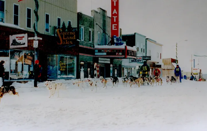 Sled dogs racing past the theater